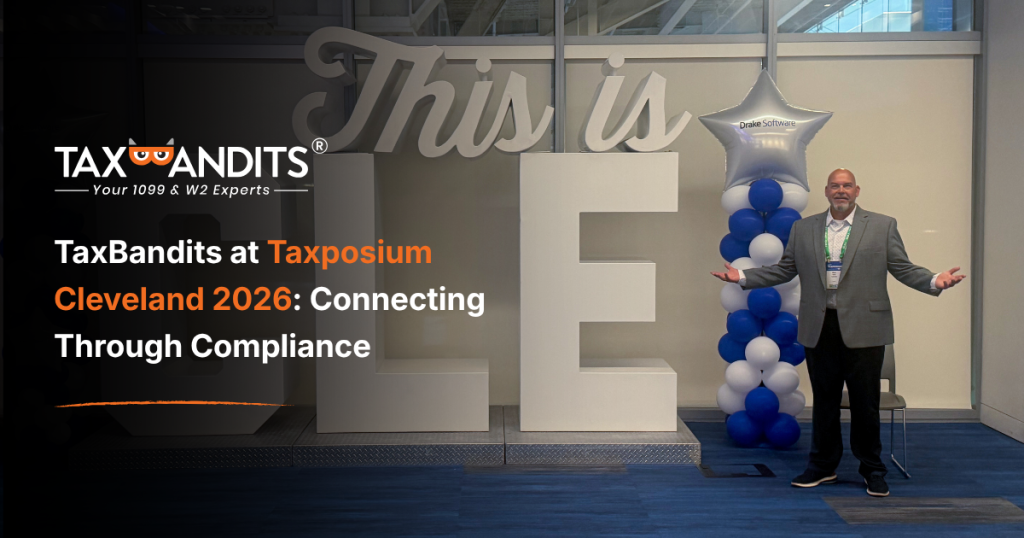 TaxBandits at Taxposium Cleveland 2026: Connecting Through Compliance. Pictured: A TaxBandits representative at Taxposium Cleveland 2026 tax professional conference standing beside a CLE display.